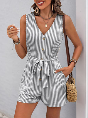 Button-front striped romper with V-neck, sleeveless design, and tie waist in gray and white stripes.