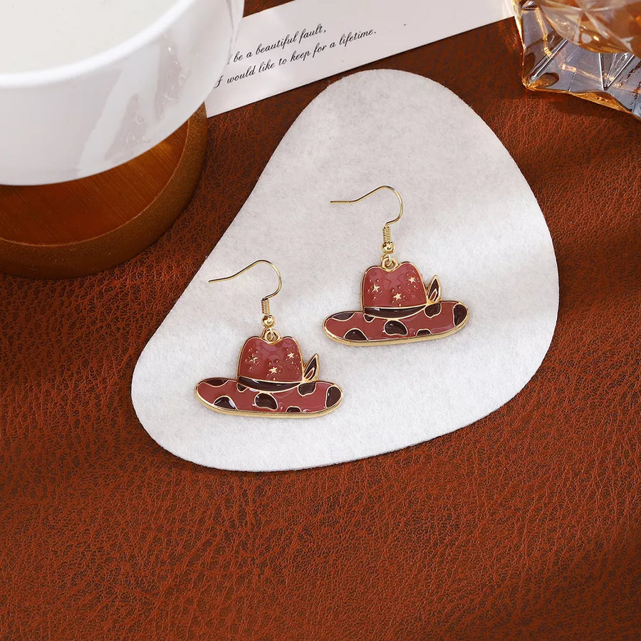 gold earrings featuring dangle and cow print