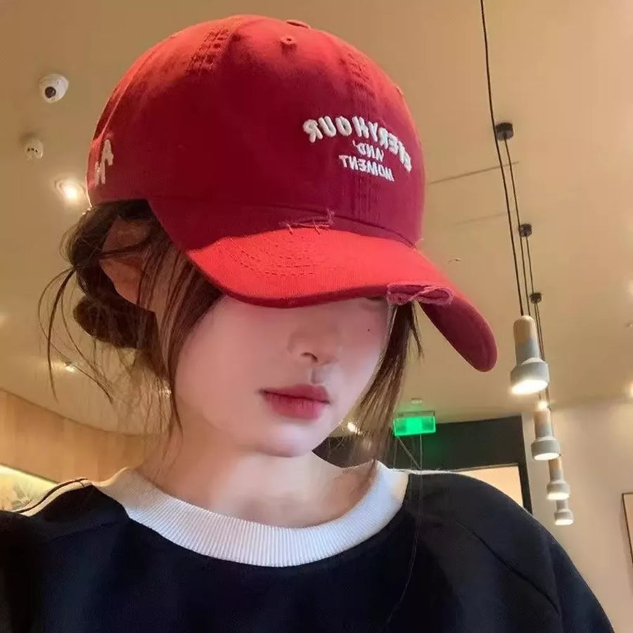 Burgundy distressed embroidered baseball cap with white text detail.
