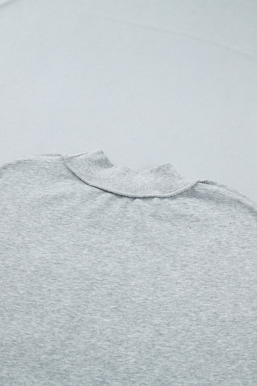 light gray sweatshirt with exposed seam and long sleeve