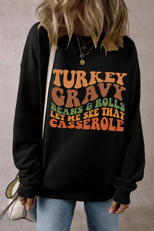 Black crewneck sweatshirt with Thanksgiving graphic text.