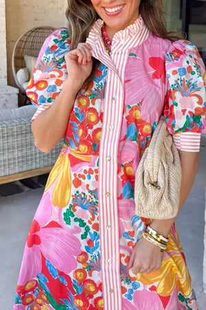 Vibrant floral maxi dress with pink stripes, puff sleeves, button front, and ruffled collar.