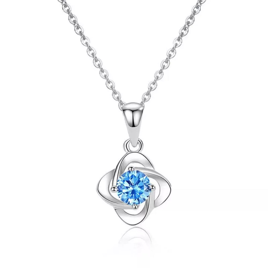 Delicate silver four-leaf clover necklace with blue crystal charm