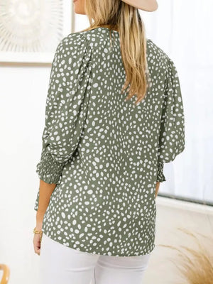 Green animal print blouse with smocked half sleeves and puff shoulders.