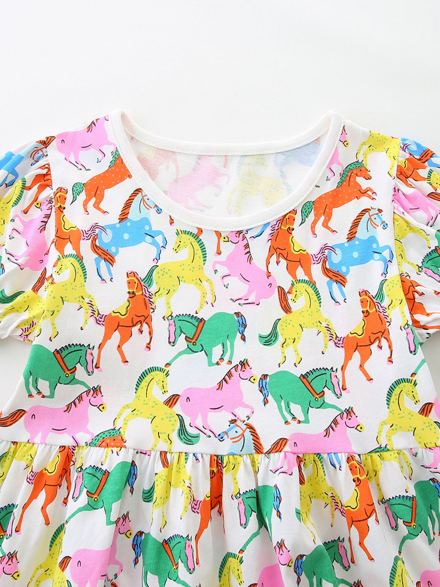 Toddler cotton dress with playful multi-color horse print and puff sleeves.