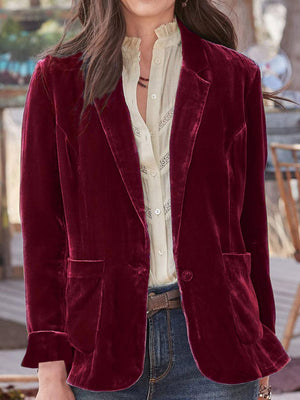 Burgundy velvet blazer with rolled cuff detail and buttoned front, styled with jeans.