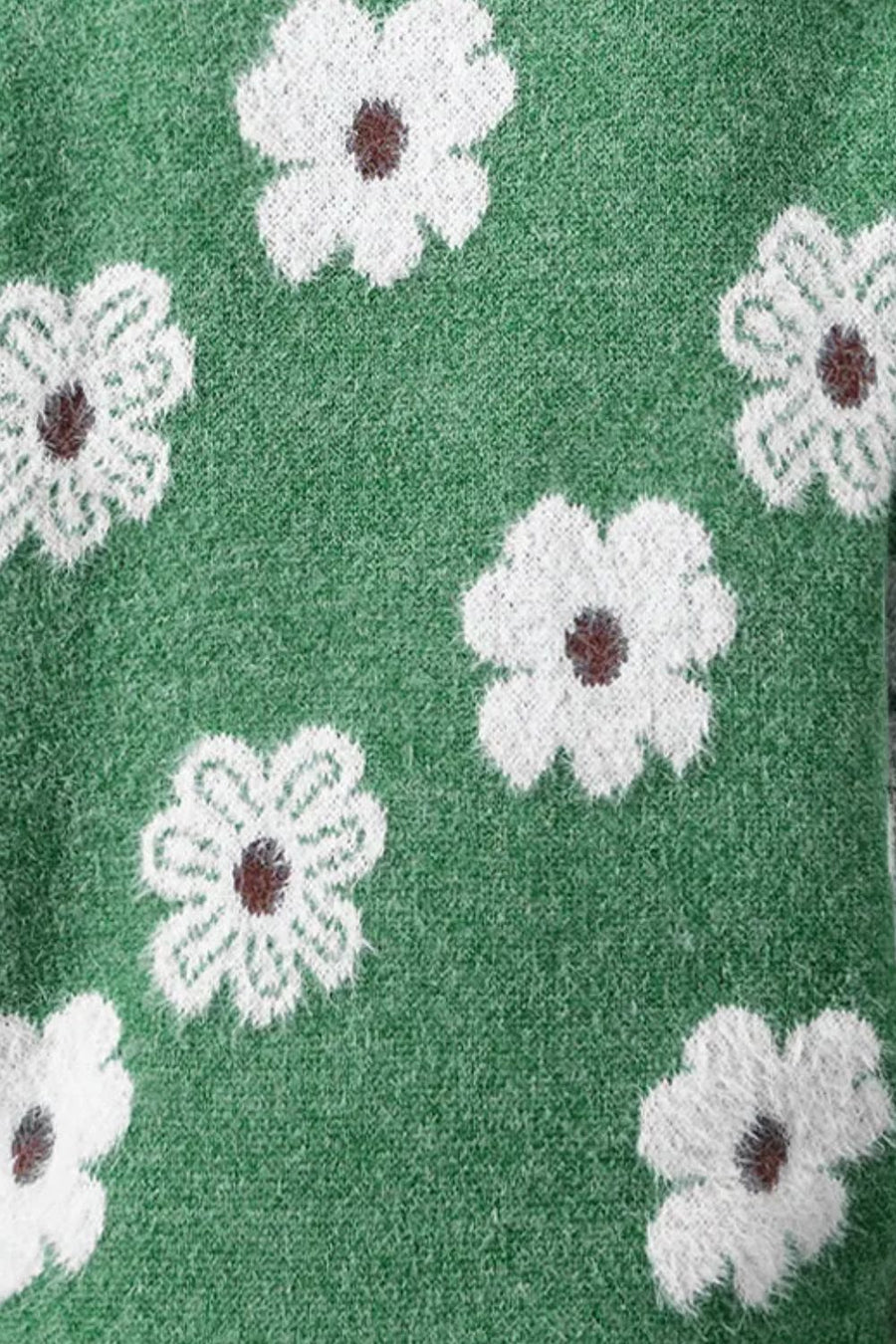 Dark green acrylic sweater with white intarsia floral pattern and brown centers.