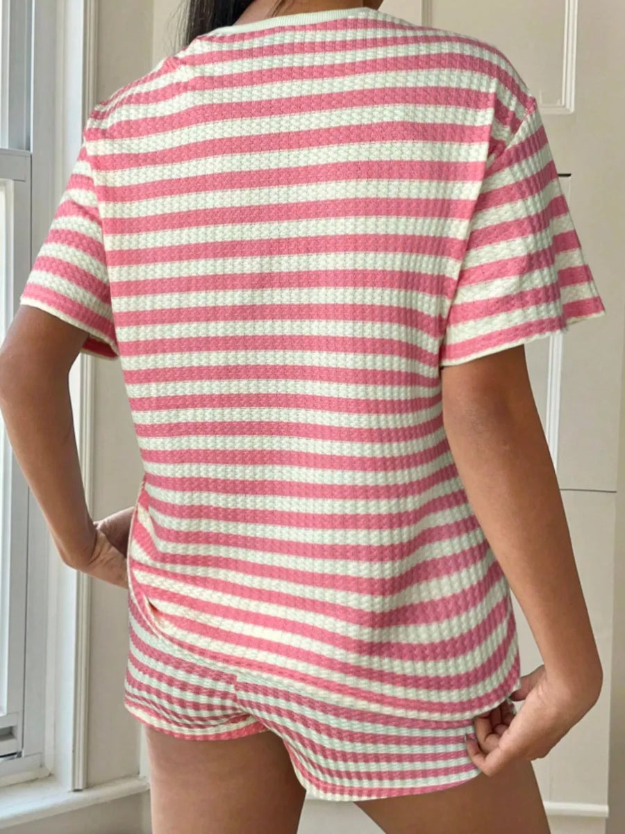 Pink and white striped waffle knit two-piece loungewear set with crew neck top and shorts.