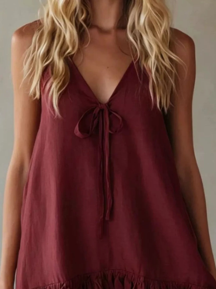 Burgundy tie-front mini dress with V-neck and ruffle hem.