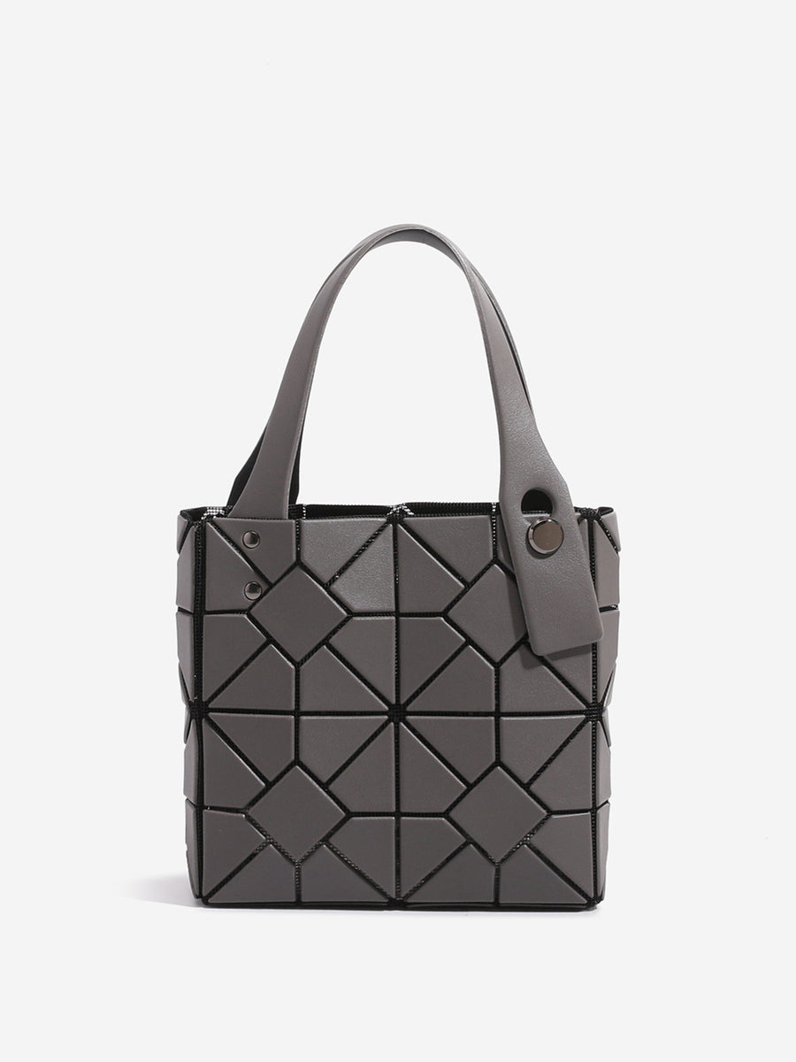 Black handbag featuring geometric panels and geometric