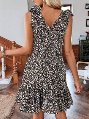 Floral tie strap mini dress with ruffled hem and V-neckline.