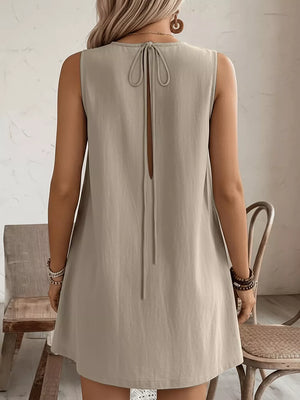 Khaki sleeveless dress with back tie detail and a subtle open back.