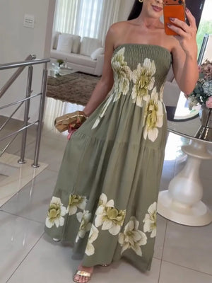 Strapless tiered maxi dress in olive green with a white floral print and smocked bodice.