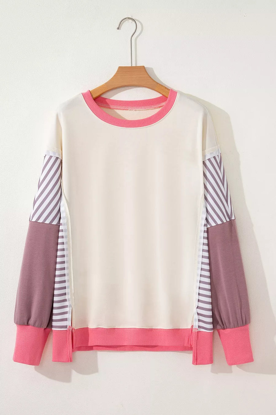 hot pink sweatshirt featuring exposed seam and color-block