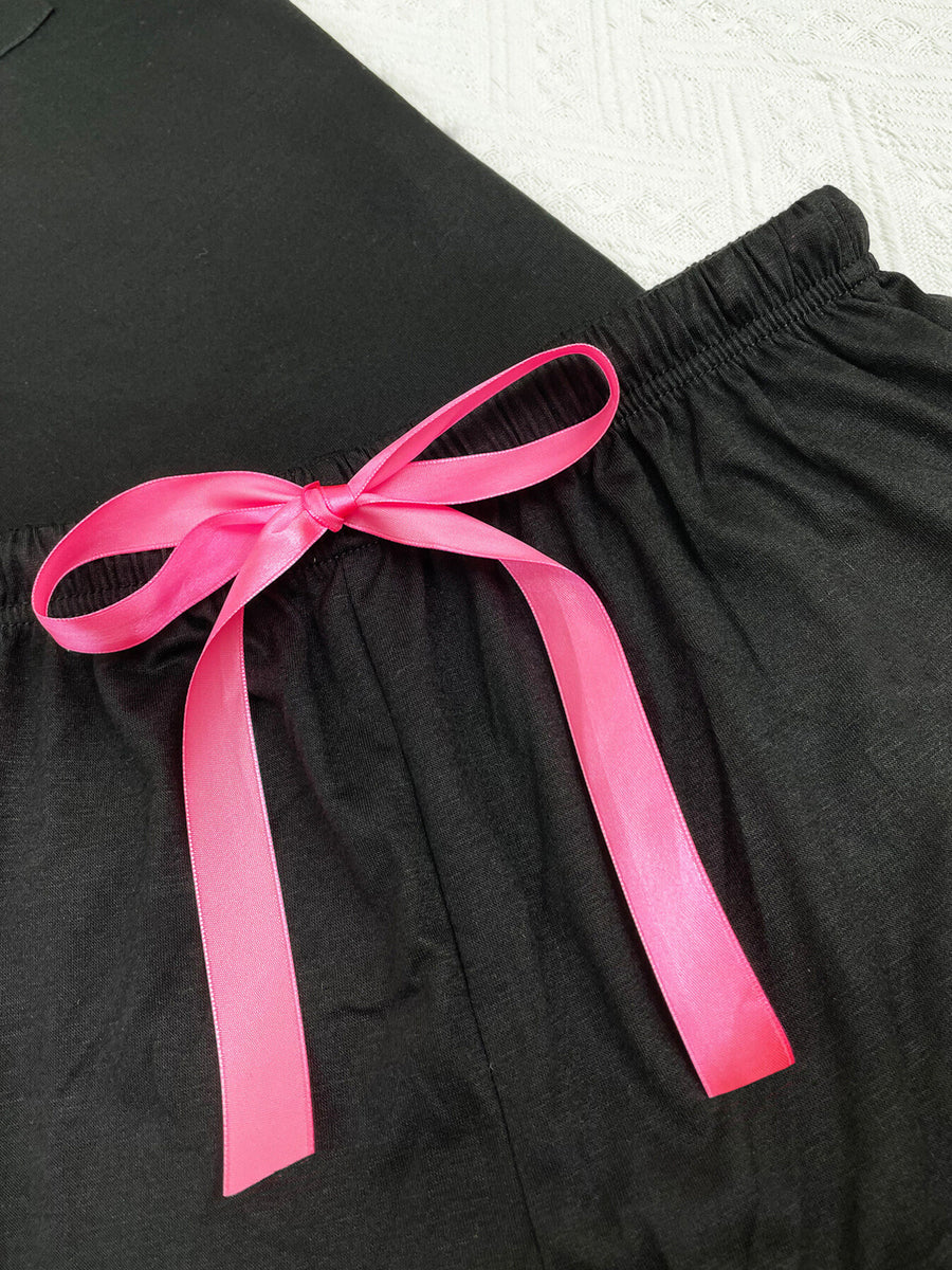 Black shorts with pink ribbon tie and elastic waistband