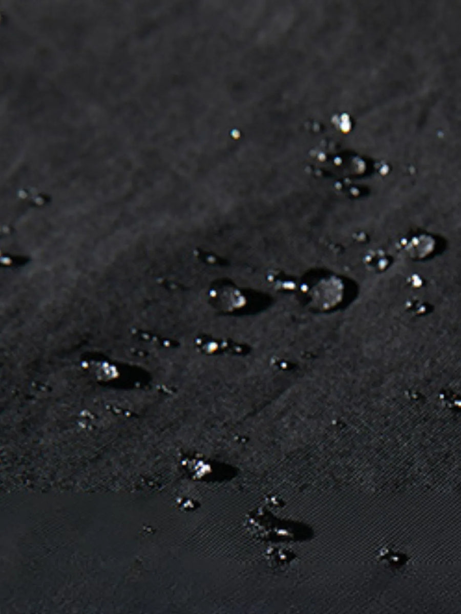 Black oversized cargo trousers with water droplets on fabric