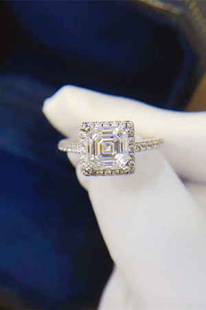 Silver Asscher cut moissanite halo ring with pavé band.