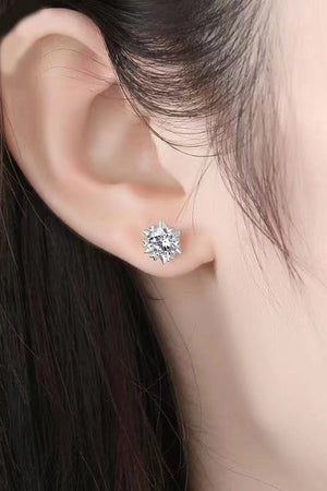Silver celestial cut moissanite stud earrings with a starburst design.