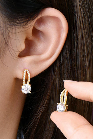 Gold stud earrings with a single round moissanite stone and a pave crystal halo.