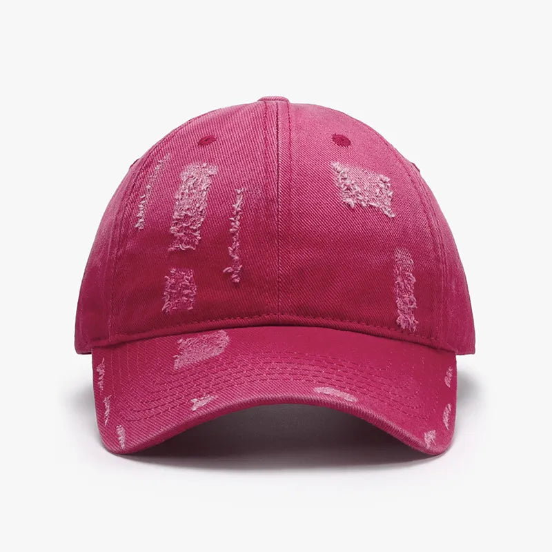 Distressed cotton baseball cap in hot pink with frayed details.