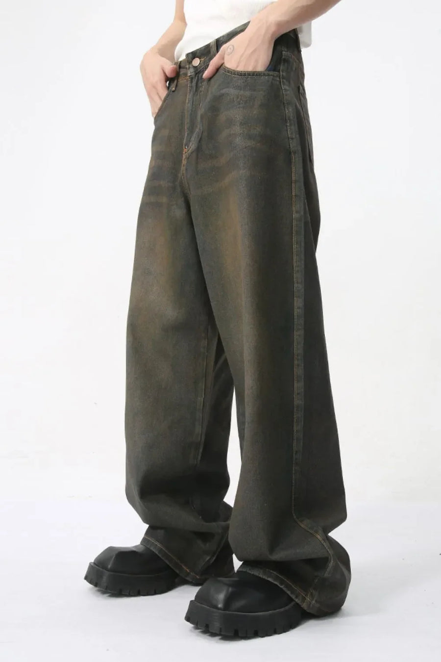 Faded oversized denim trousers in dark wash, featuring a relaxed fit and wide leg.