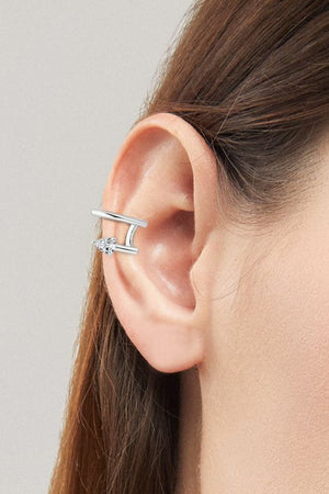 Silver spiral diamond ear cuff with a double band design and clear stones.
