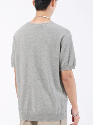 Men's gray knit t-shirt with short sleeves and a textured pattern.