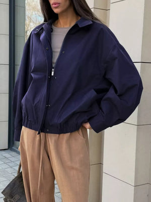 navy blue bomber jacket with hip-length and zip-front, snap