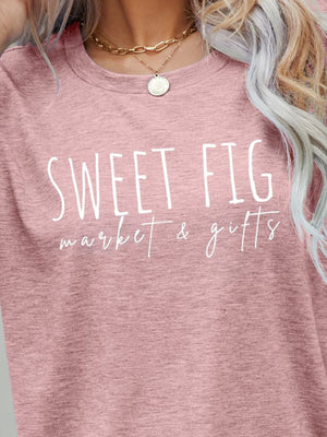 Blush pink graphic t-shirt with white "Sweet Fig Market & Gifts" text, crew neck.