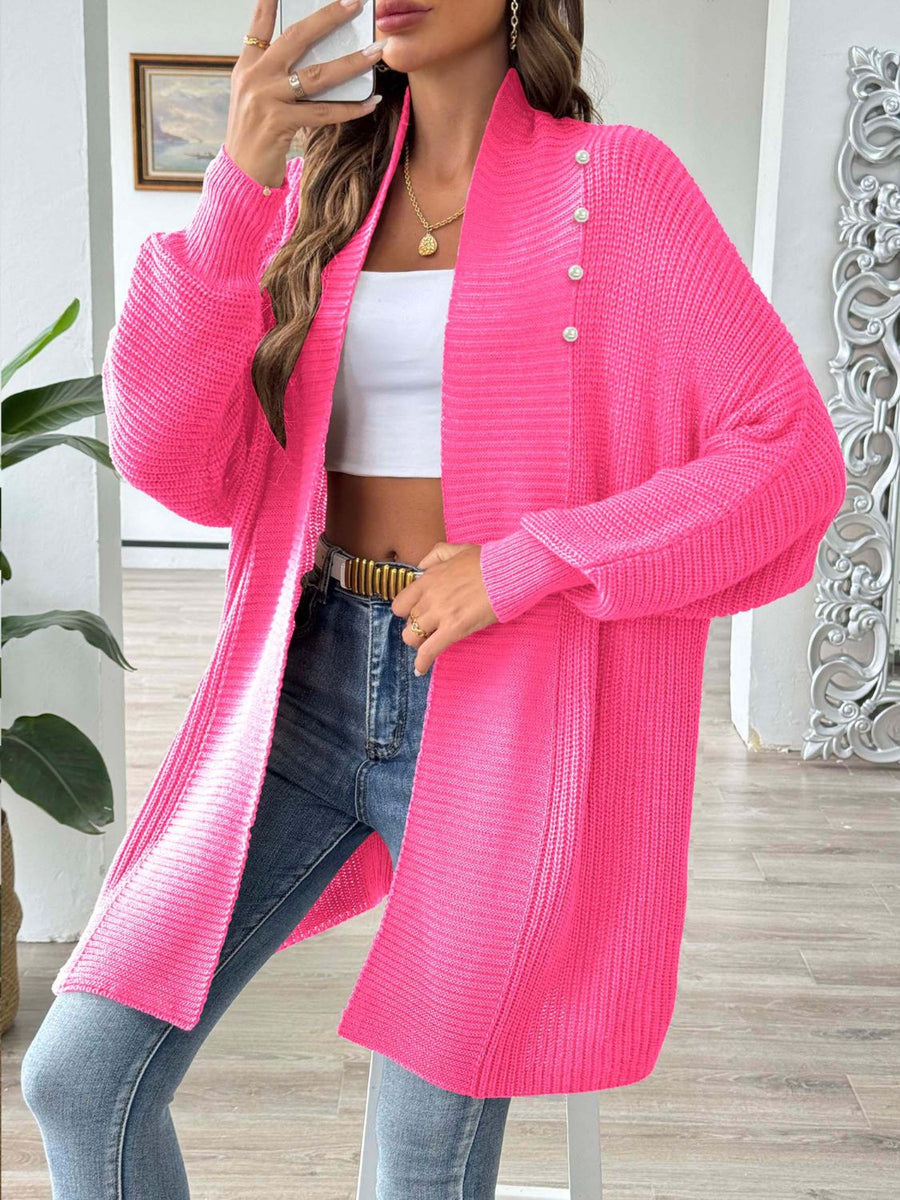 Pearl button ribbed knit cardigan in strawberry pink with a relaxed fit and open front.