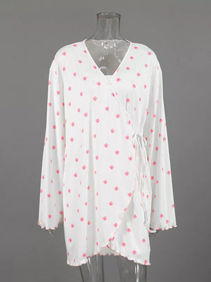 cream wrap dress with ruffled cuffs and long sleeve