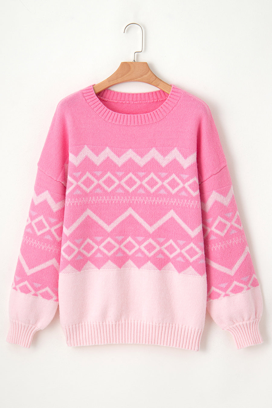 Pink acrylic knit sweater with geometric colorblock pattern, crewneck, and ribbed cuffs.