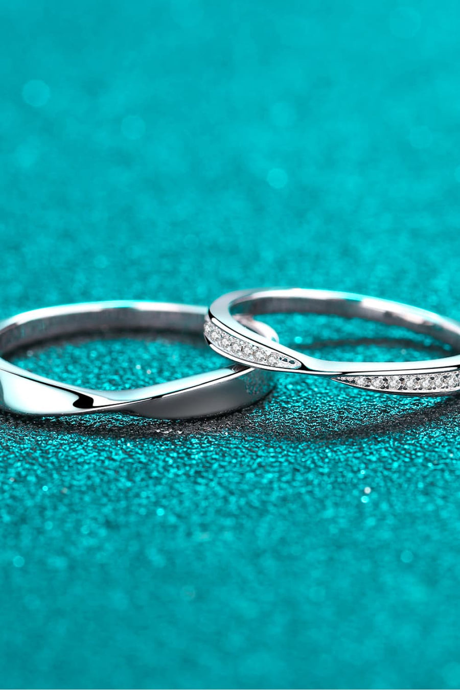 Silver band rings, one plain twisted, one with small clear stones