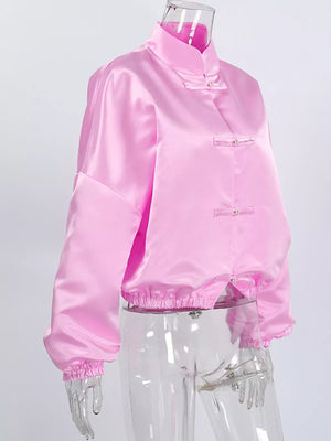 pink button-up shirt with decorative button and bishop sleeve