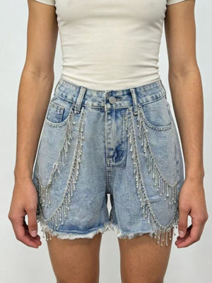Sky blue denim shorts with rhinestone chain embellishments and frayed hem