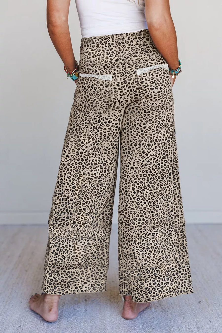 black wide-leg pants featuring pocketed and leopard-print