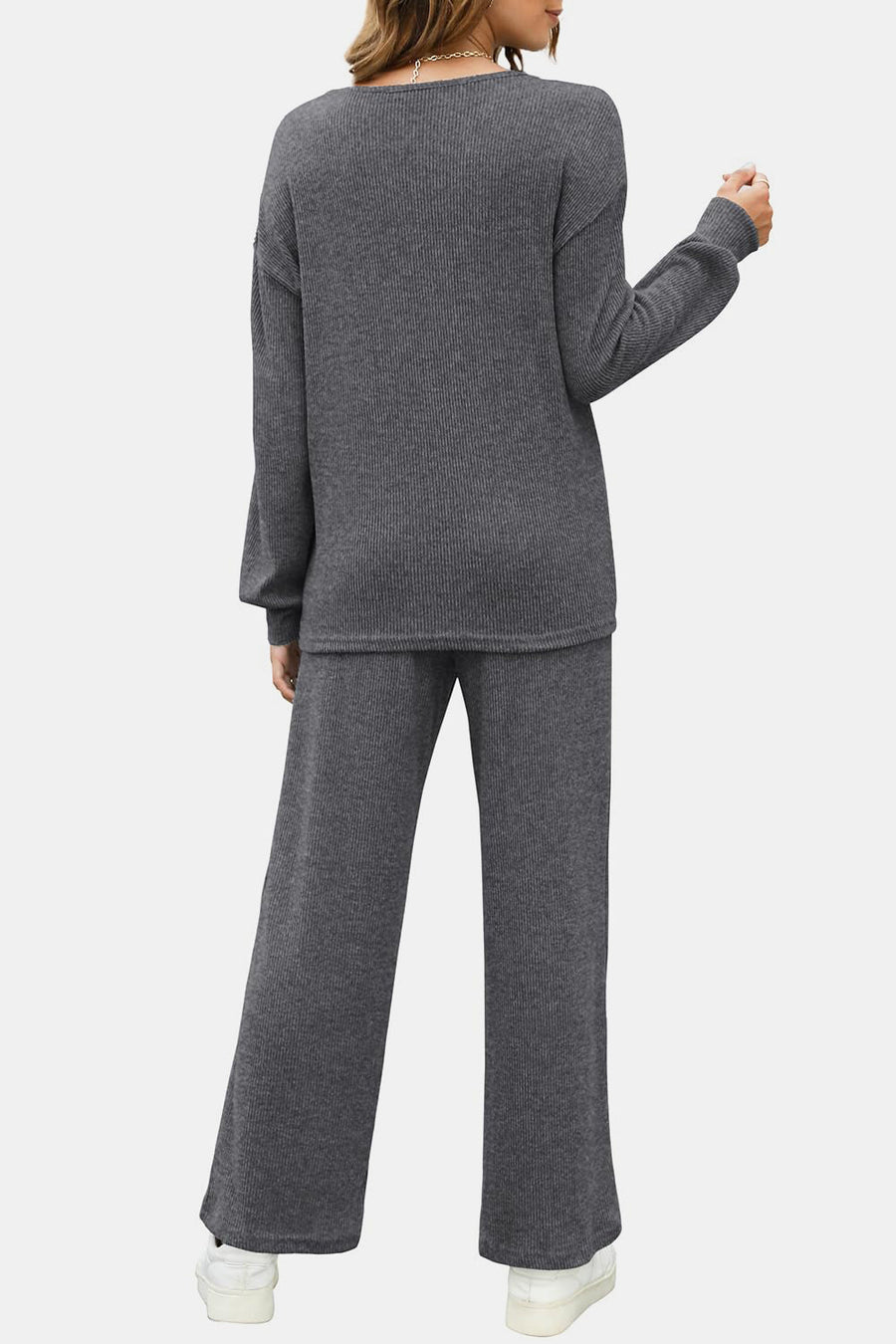 Dark gray ribbed knit lounge set with crew neck sweater and wide leg pants.