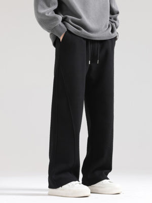 Men's black wide-leg sweatpants with drawstring waist and seam detail.