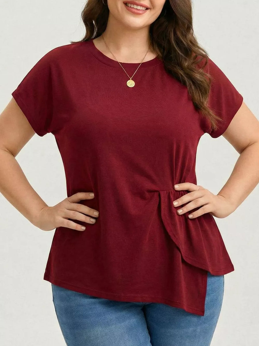 Plus-size burgundy crew neck t-shirt with asymmetrical ruched hem detail.