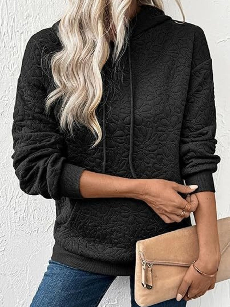 Black pullover hoodie featuring drawstring and floral