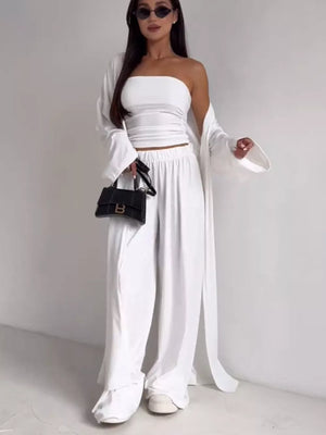 White three-piece maternity set with strapless crop top, wide-leg pants, and long cardigan.