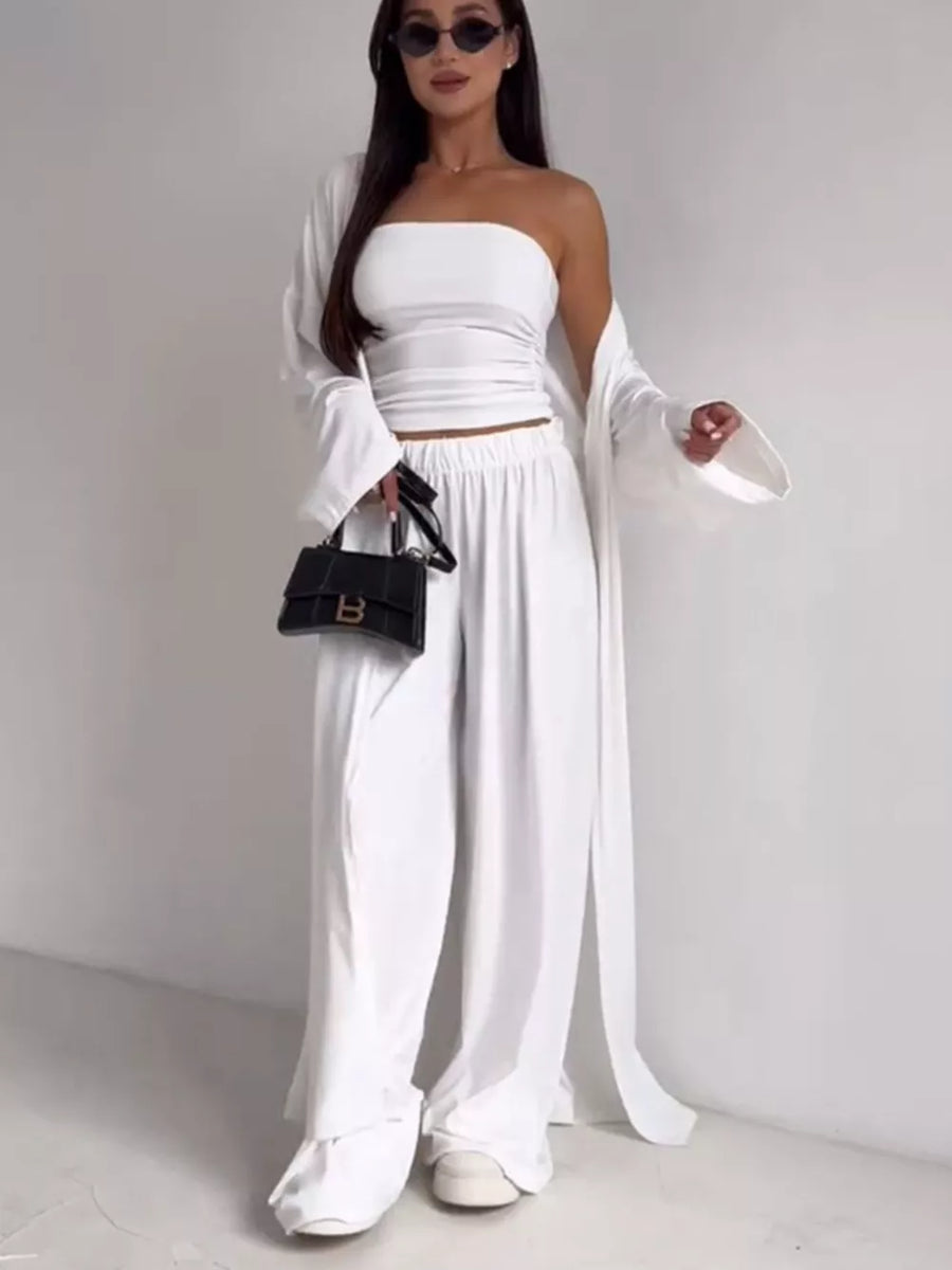 White three-piece maternity set with strapless crop top, wide-leg pants, and long cardigan.