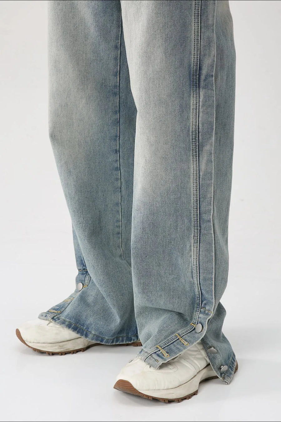 Baggy denim jeans in medium wash with side snap hem detail