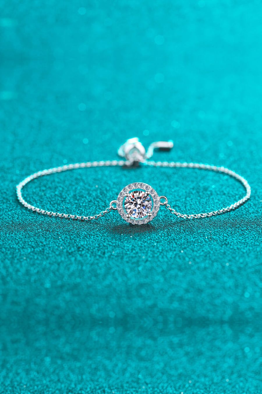 Silver halo moissanite adjustable bracelet with a sparkling round center stone.