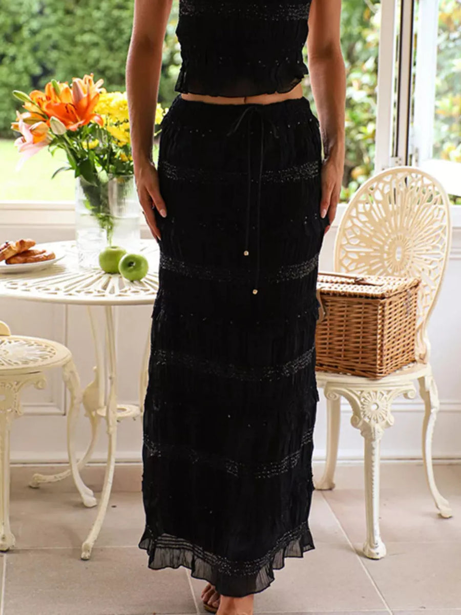 Black smocked maxi skirt with tiered ruffle hem and drawstring waist
