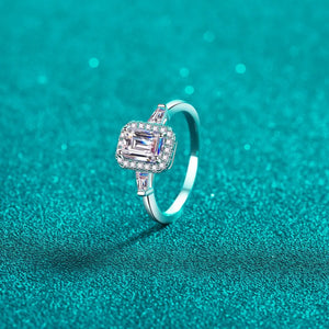 Emerald cut moissanite halo ring in sterling silver with baguette accents