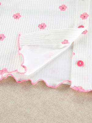 White knit lounge set with pink floral print, button front, and frill trim.