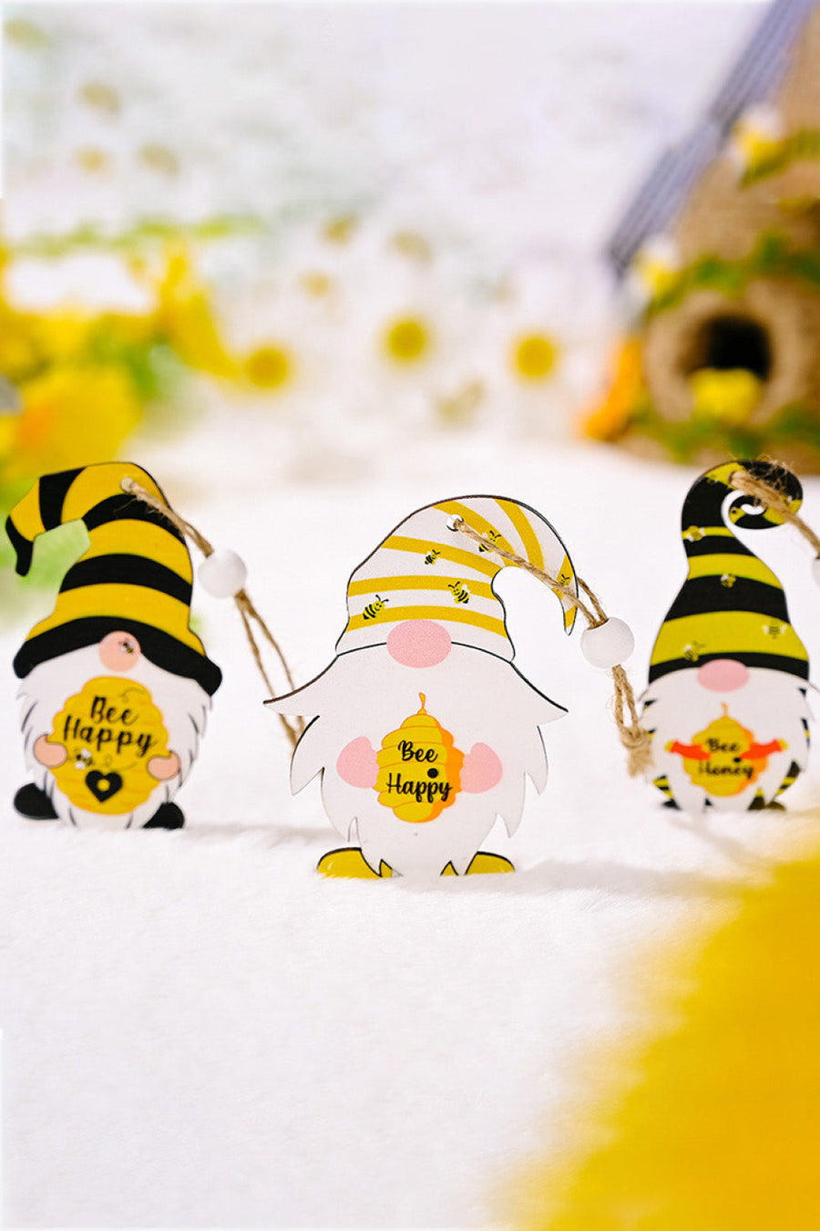 Bee gnome ornaments in yellow and black with bee designs and "Bee Happy" text.