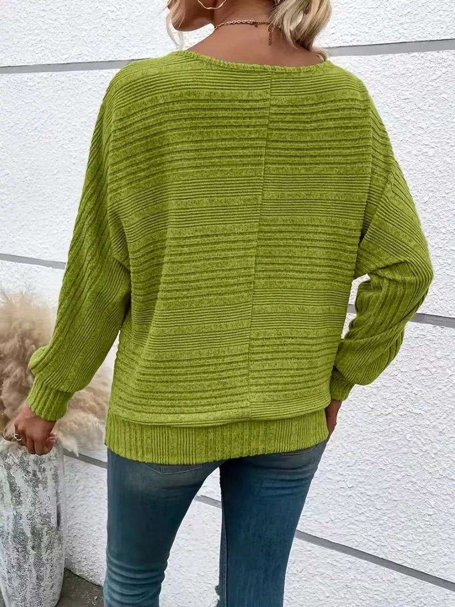 Sage ribbed acrylic sweatshirt with dolman sleeves and crew neck, styled with jeans.