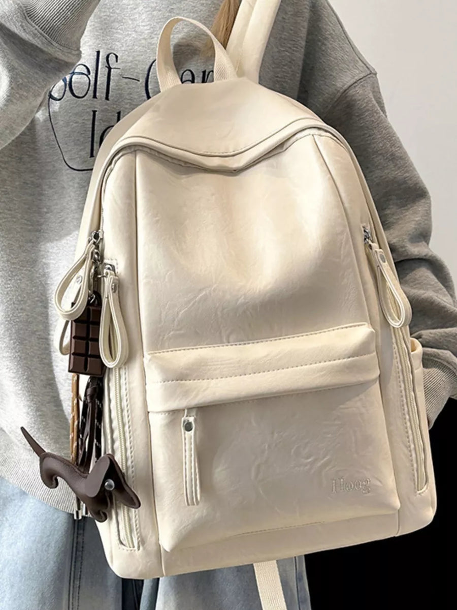 Chic pu leather medium backpack in white with cute dachshund and chocolate bar charms.